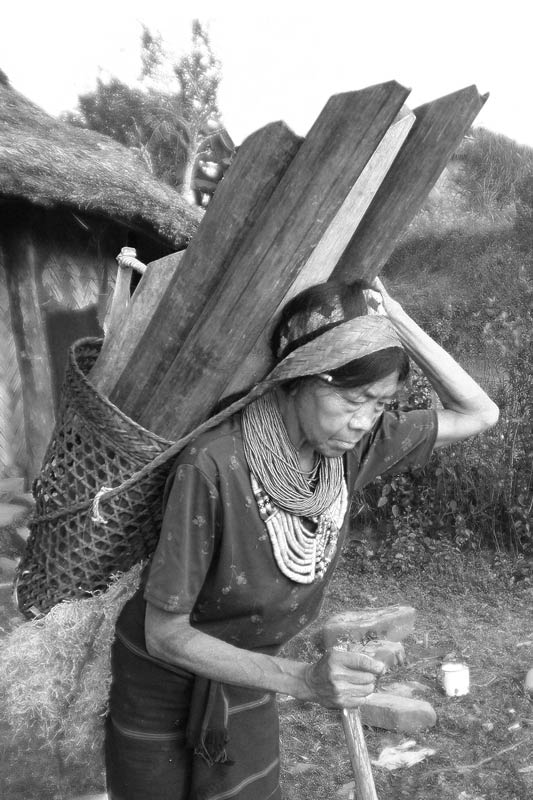 Water portraits - An old Naga woman bringing water from a spring located down the hill, since Naga villages are always located on the hilltop – Mon district, Nagaland